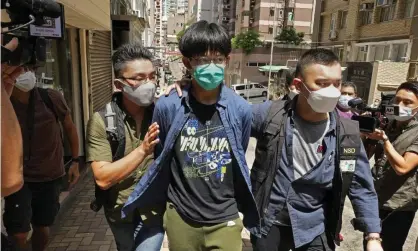  ?? Photograph: Vincent Yu/AP ?? Police officers arresting one of the students on Wednesday after searching his home.