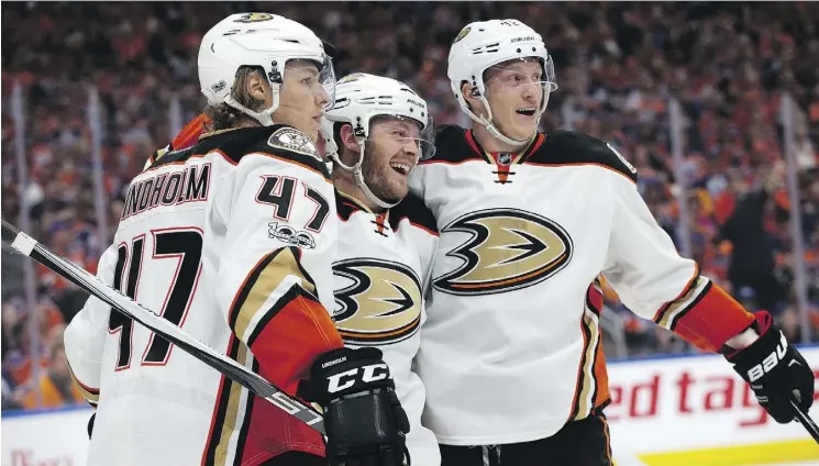  ?? DAVID BLOOM ?? The Anaheim Ducks’ Hampus Lindholm, left, Chris Wagner and Josh Manson celebrate a goal in the second period of Sunday’s game against the Edmonton Oilers.