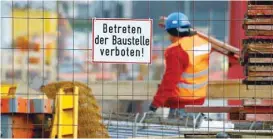  ??  ?? A worker of German constructi­on company walks over a constructi­on site in Essen. — Reuters