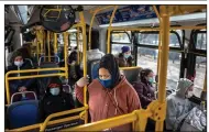  ?? (The New York Times/Jonah Markowitz) ?? A woman wears her mask on a bus in New York in this file photo. A new federal order requiring travelers to wear masks goes beyond the “masking for interstate travel” previously set by the White House.