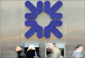  ?? PHOTO: REUTERS ?? A woman uses an ATM at a Royal Bank of Scotland (RBS) branch in London. The bank may have reached a “turning point” after scrapping plans to sell its Williams & Glyn banking unit.