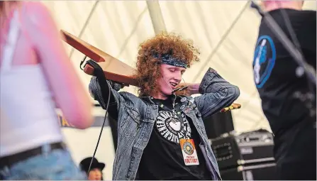  ?? ANDREJ IVANOV WATERLOO REGION RECORD ?? Alex Van Cappellen, 15, loses his glasses while shredding a solo at the recital for the Grand River Blues Camp during the Kitchener Blues Festival on Friday. Young musicians, working with mentors steeped in the blues, were taught to play together as a band.