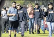  ?? Robert Gauthier Los Angeles Times ?? PARENTS pick up their children from Sal Castro Middle School hours after a shooting Thursday.