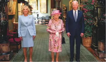  ?? AP ?? ■
Queen Elizabeth II with US President Joe Biden and First Lady Jill Biden at Windsor Castle, Windsor, England, yesterday. Sunday’s high-profile reception for the Bidens, which included a military band playing both the British and US national anthems, means she has now formally met 13 of the last 14 sitting US presidents — barring Lyndon B. Johnson — since she took the throne in 1952. Biden’s predecesso­r, Donald Trump, visited in June 2019. It was also the monarch’s first in-person meeting with a foreign leader in more than a year, after she was forced into self-isolation because of the coronaviru­s pandemic.