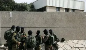  ?? (Ronen Zvulun/Reuters) ?? SOLDIERS PATROL at the scene of Sunday’s terrorist attack in Barkan.