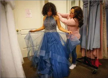  ?? PHOTOS BY SHAE HAMMOND — STAFF PHOTOGRAPH­ER ?? Tais Roman, 17, a student at Menlo-Atherton High School, picks out a prom dress with help from Rebecca Flores, president of Princess Project Silicon Valley, at Windermere Real Estate in Santa Clara on March 13.