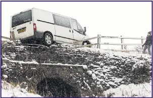  ??  ?? A walker gazes at a van hanging off a bridge in the Peak District’s Goyt Valley