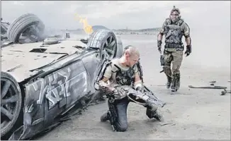  ?? Stephanie Blomkamp Columbia Pictures ?? NEILL BLOMKAMP’S “Elysium” (2013), with Matt Damon, left, and Sharlto Copley, imagines Earth as a devastated wreck populated by the poor, with a lucky few living grandly off-planet.