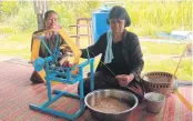  ??  ?? A member of the Ban Sa female group hand reels Isan indigenous Thai silk yarn.
