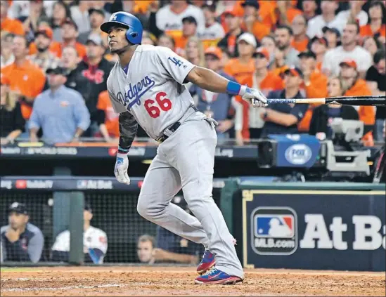  ?? Wally Skalij Los Angeles Times ?? WITH THE DODGERS TRAILING 12-9 going into the ninth inning, Yasiel Puig gave them life with a two-run homer before Chris Taylor delivered the tying single.