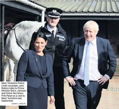  ??  ?? West Yorkshire Police Chief constable John Robins talks to Prime Minister Boris Johnson and Home Secretary Priti Patel on a visit to West Yorkshire last September
DANNY LAWSON