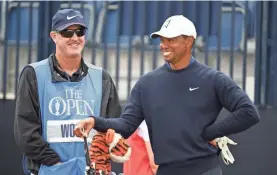  ?? THOMAS J. RUSSO/USA TODAY SPORTS ?? Tiger Woods got his first taste of links golf at venerable Carnoustie on the practice range.