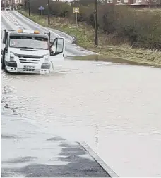  ??  ?? A van struggles through flooding on Murton Lane.