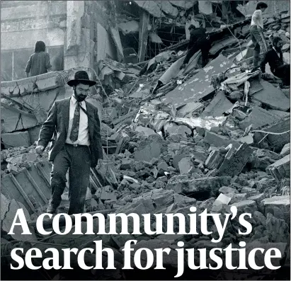  ?? PHOTOS: GETTY IMAGES ?? Above: A member of the community picks his way through the rubble of the Amia centre in Buenos Aires. Left: Daniel Pomerantz, survivor and current Amia chief executive and (next to
him) former Iranian president Ali Akbar Rafsanjani, a named suspect and subject of an Interpol red notice