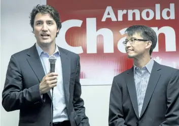  ?? CHRIS YOUNG/THE CANADIAN PRESS ?? Federal Liberal Leader Justin Trudeau speaks to supporters as he visits Liberal candidate for Scarboroug­h-Agincourt Arnold Chan, right, at his campaign office in Toronto in 2014. Chan has died of cancer.