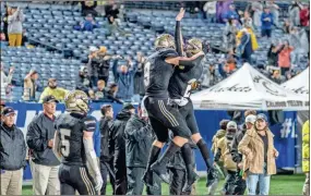  ?? ?? Calhoun seniors Quin Smith and Brendan Gray celebrate a Yellow Jackets’ touchdown catch by Smith.