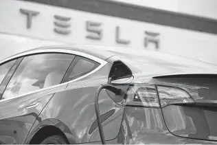  ?? David Zalubowski / Associated Press ?? Austin-based Tesla reported Sunday that it delivered 936,000 cars in 2021, an 87 percent increase from the year before, despite the computer chip shortage.