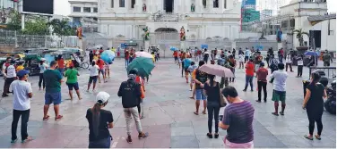  ?? Associated Press ?? Devotees wait for their turn to go inside a church in Manila on Friday.