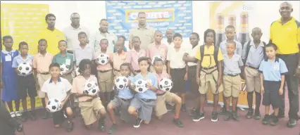  ??  ?? Representa­tives from the participat­ing schools in the Courts Pee Wee U11 Primary School football tournament posing with members of the launch party inclusive of Petra Organizati­on Director Troy Mendonca (third from left), Marketing Director of Courts...