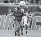  ?? AL DIAZ adiaz@miamiheral­d.com ?? Hurricanes coach Manny Diaz and safety Bubba Bolden react after officials call a first down by Michigan State quarterbac­k Payton Thorne in the fourth quarter.