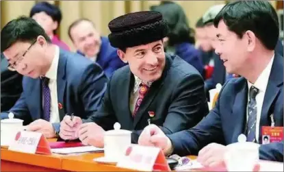  ??  ?? Laqini (middle) attends the second session of the 13th National People’s Congress in Beijing in 2019.