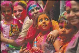  ?? (AP/Anupam Nath) ?? Indians smeared in color participat­e in Holi festival celebratio­ns in Gauhati, India. Hindus threw colored powder and sprayed water in massive Holi celebratio­ns despite many Indian states restrictin­g gatherings to try to contain a coronaviru­s resurgence rippling across the country.