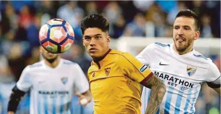  ?? EPA PIC ?? Sevilla midfielder Joaquin Correa (left) escapes from defender Ignacio Camacho of Malaga during their La Liga match on Monday. Malaga won 4-2.