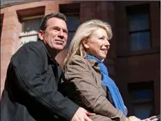  ??  ?? Denver Broncos head coach Gary Kubiak and his wife Rhonda soak in the moment during a parade for the NFL football Super Bowl champions Tuesday.