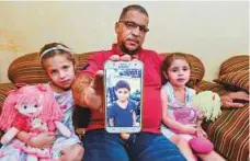  ?? Ahmed Ramzan/Gulf News Archives ?? Obaida’s father Ebrahim Sedqi with his daughters Aya and Tala at his residence in Sharjah on May 30 last year.