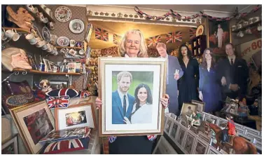  ??  ?? Royal retainer: Tyler with a framed photograph of Prince Harry and his fiancee at her home in north London. — AFP