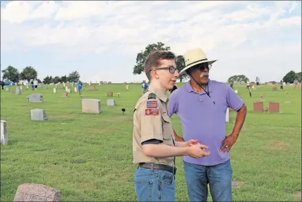  ?? [PETER ADAMS/PROVIDED] ?? Grant Lyon, a member of Scouts BSA Troop 0314, talks with Andre Head, co-founder of the Coltrane Group, during Lyon's Eagle Scout project at Trice Hill Cemetery in Forest Park.