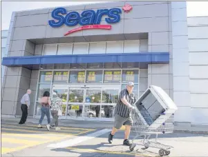  ?? CP PHOTO/RYAN REMIORZ ?? Bargain hunters are seen at the Sears store Friday, July 21, in St. Eustache, Quebec. Sears Canada is facing a social media campaign calling for a boycott after the company said it planned on paying millions in bonuses to keep executives on board...