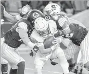  ?? Howard Simmons Associated Press ?? TOMMY DeVITO, Syracuse’s backup quarterbac­k, is sacked by Notre Dame defenders.