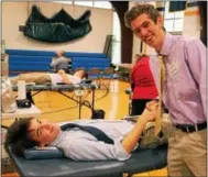  ??  ?? Devon Prep Senior Jack Marquis of Wayne (left) congratula­tes fellow senior Wilson Camp of Spring City as he donated blood to the school’s annual Red Cross Blood Drive.
