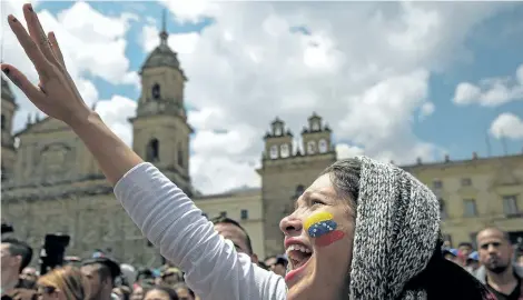  ?? RAUL ARBOLEDA/GETTY IMAGES ?? Venezuelan­s residing in Colombia gather at Bolivar square in Bogota to take part in a symbolic plebiscite called by the Venezuelan opposition on President Nicolas Maduro’s project of a future constituen­t assembly, on Sunday.