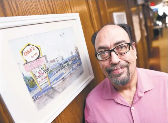  ?? Arnold Gold / Hearst Connecticu­t Media ?? Artist Dave Stannard is photograph­ed by one of two donated oil pastel paintings that hang outside of the Assessor's Office at West Haven City Hall depicting Chick's Drive-In on Friday. The other depicts The Bilko Company, which is slated to be torn down.