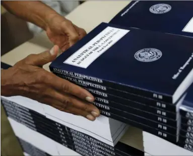  ?? CAROLYN KASTER — THE ASSOCIATED PRESS ?? On May 19, a GPO worker stacks copies of “Analytical Perspectiv­es Budget of the U.S. Government Fiscal Year 2018” onto a pallet at the U.S. Government Publishing Office’s (GPO) plant in Washington.