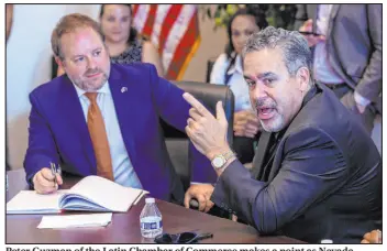  ??  ?? Peter Guzman of the Latin Chamber of Commerce makes a point as Nevada Treasurer Zach Conine listens at the Asian Community Developmen­t Council.