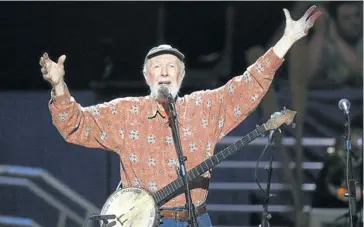  ?? Picture: AFP ?? VOICE OF CONSCIENCE: Pete Seeger performs at Madison Square Garden in New York at a concert to mark his 90th birthday
