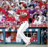  ?? JOE ROBBINS / GETTY IMAGES ?? Reds reliever Michael Lorenzen launches a pinch-hit grand slam Saturday against the Brewers in Cincinnati. In his last five trips to the plate, Lorenzen has hit three home runs, singled and walked.