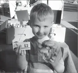  ?? Courtesy photo
/ Farms oftuolumne County ?? Seven-year-old Atlas Cox shows a voucher he used at the Peaceful Valley Farmers Market's Kids' Day to buy mushrooms. The goal of the annual Kids' Day at the market is to encourage children to eat a healthy diet full of fresh fruits and vegetables.