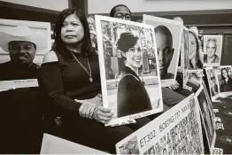  ?? AFP via Getty Images file photo ?? Family members hold photos of Boeing 737 MAX crash victims as FAA Administra­tor Stephen Dickson testifies before a House committee in December.