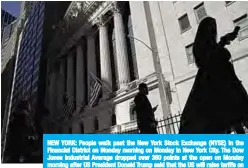  ??  ?? NEW YORK: People walk past the New York Stock Exchange (NYSE) in the Financial District on Monday morning on Monday in New York City. The Dow Jones Industrial Average dropped over 360 points at the open on Monday morning after US President Donald Trump said that the US will raise tariffs on goods imported from China. —AFP