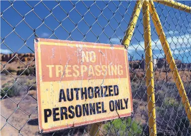  ?? JIM THOMPSON/JOURNAL ?? A sign at a United Nuclear Corp. Superfund site. Contaminat­ion from the now-closed Northeast Church Rock uranium mine, mill and disposal sites has prompted federal cleanup and health impact studies.