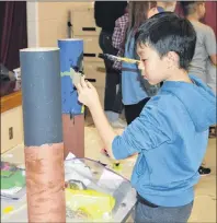  ?? DAVE STEWART/THE GUARDIAN ?? Evan Liu, a Grade 6 student at West Royalty Elementary School in Charlottet­own, concentrat­es on painting his legend poles on Thursday afternoon. The event was part of the ArtsSmarts P.E.I. program which promotes creativity in Island students.