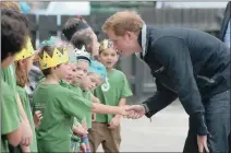  ?? PICTURE: EPA ?? MEET AND GREET: Britain’s Prince Harry greets young pupils during a visit to Halfmoon Bay School on Stewart Island in New Zealand yesterday. The prince, who is on an eight-day trip to New Zealand, is on a visit to Stewart Island, the country’s...