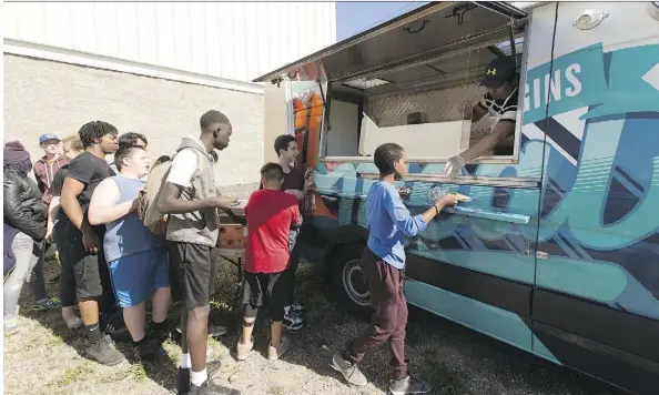 ?? GREG SOUTHAM ?? Rodel Luquingan serves food from the new Hope Mission Food Truck on Friday. There are plans to take the vehicle — outfitted with a grill, broiler, refrigerat­or and other kitchen appliances — to Calgary and Red Deer, among other communitie­s across the...