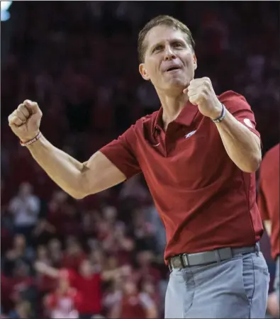  ??  ?? Arkansas Coach Eric Musselman celebrates after a Razorbacks’ basket in December. A year ago today, Musselman was joined by his wife Danyelle and children during a news conference at Walton Arena in Fayettevil­le as he was introduced as Arkansas’ coach. “Everything in the first year happens at almost warp speed,” Danyelle Musselman said.
(NWA Democrat-Gazette/Ben Goff)
