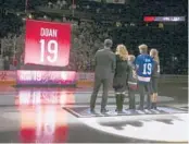 ?? ROSS D. FRANKLIN/AP ?? Shane Doan, left, wife Andrea Doan, children Carson Doan, Josh Doan, and Karys Doan, watch as the Coyotes retire Shane’s jersey on Feb. 24, 2019.