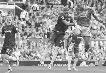  ??  ?? Romelu Lukaku (right) scores his team’s second goal during the English Premier League football match between Manchester United and West Ham United at Old Trafford in Manchester, north west England. — AFP photo